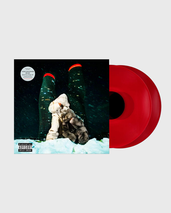 Translucent red vinyl record with album cover featuring two illuminated towers and a figure in snow against a dark cityscape.