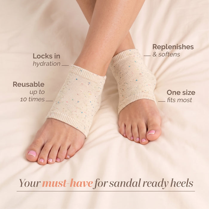 A pair of feet wearing LONDONTOWN Pedi Perfect Lightweight Heel Socks on a bed, with text noting hydration, reusability, one-size fit, and skin-softening benefits for effective heel care.