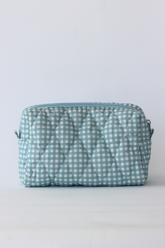 A light blue and white gingham quilted cosmetic pouch with a top zipper closure, shown against a plain white background.