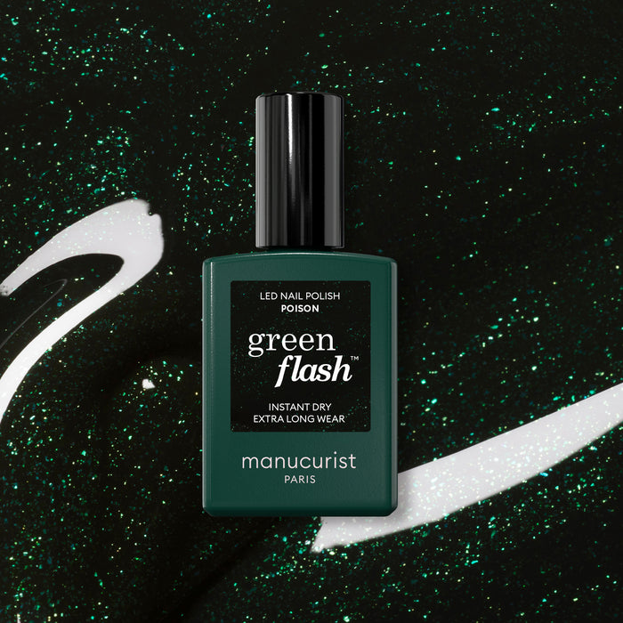A bottle of Manucurist Poison Green Flash LED nail polish sits on a sparkly matching green background with white and green swirls. The label displays “Poison” and highlights its instant dry and extra long wear features.
