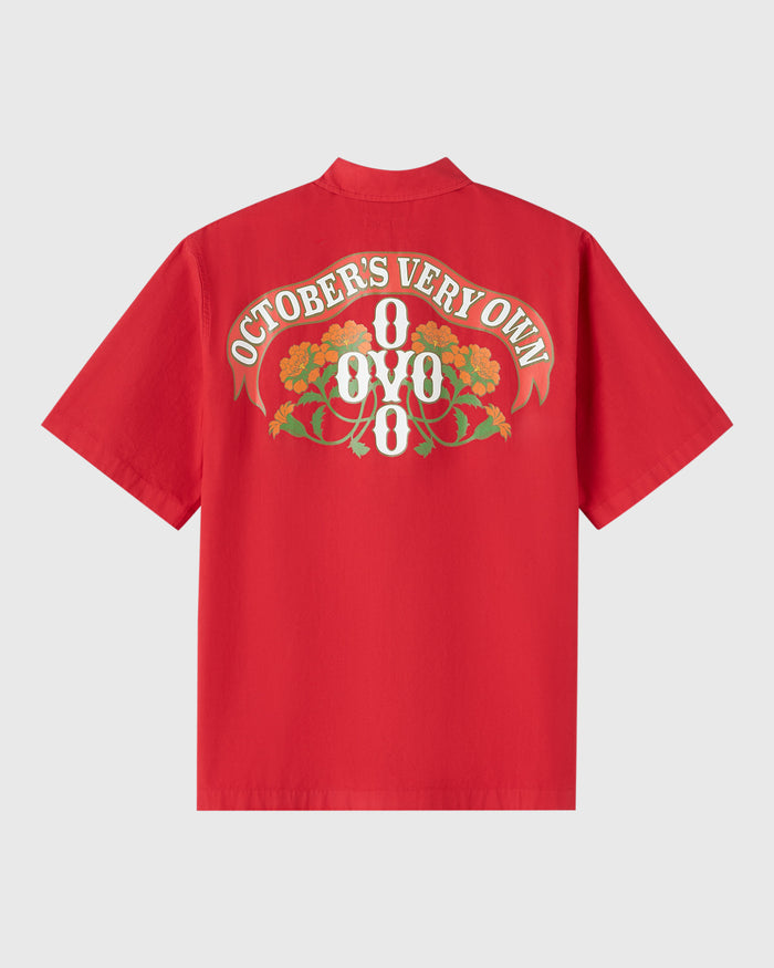 Red short-sleeve camp shirt with "October's Very Own 8/8/8" text and floral graphic on back.