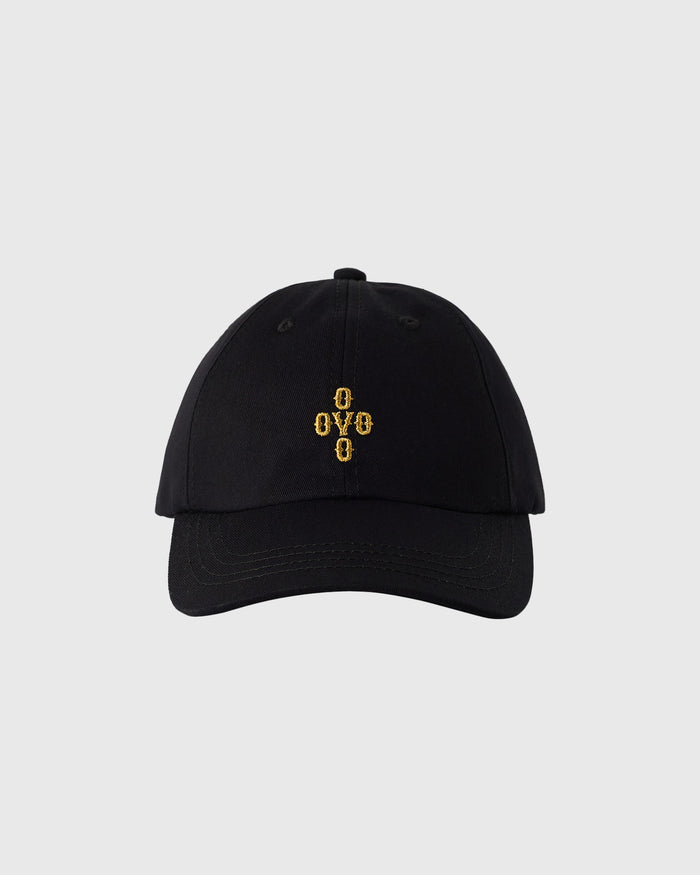 Black baseball cap with gold embroidered "OYYO" logo on front and pom pom on crown.