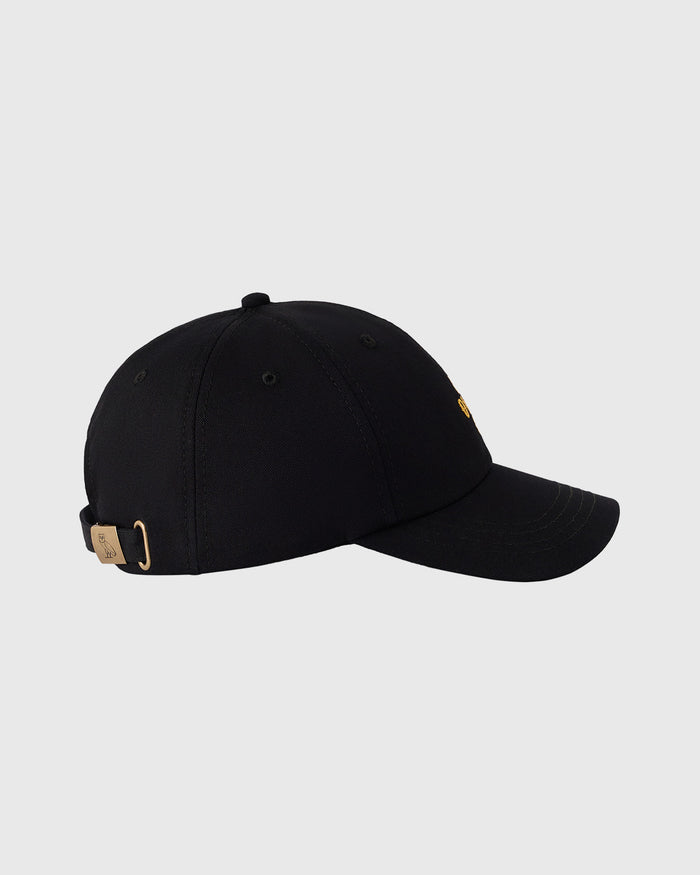 Black baseball cap with pom pom on crown and adjustable back closure with metal clasp.