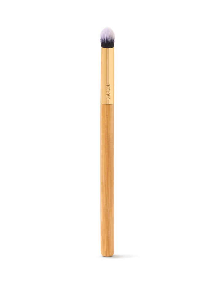Makeup brush with a wooden handle on a white background
