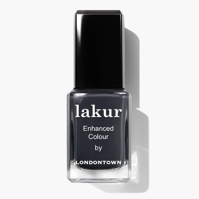 A bottle of Lakur Enhanced Colour nail polish in the shade "Put the Kettle On" by LONDONTOWN, featuring a dark gray hue and a black cap. This vegan, cruelty-free nail polish is also 16+ Free, making it an excellent choice for conscious consumers.