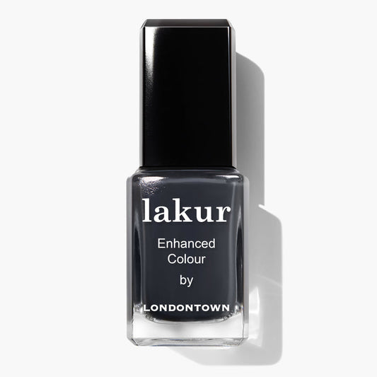 A bottle of Lakur Enhanced Colour nail polish in the shade "Put the Kettle On" by LONDONTOWN, featuring a dark gray hue and a black cap. This vegan, cruelty-free nail polish is also 16+ Free, making it an excellent choice for conscious consumers.