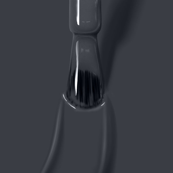 Close-up of a LONDONTOWN Put the Kettle On nail polish brush being pulled out of the bottle, showcasing vegan cruelty-free nail polish on the bristles against a grey background.