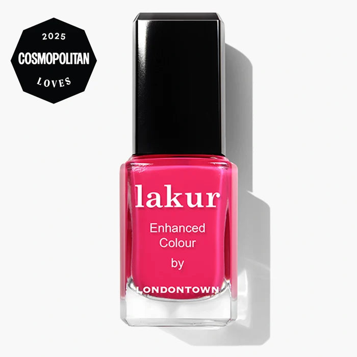 A bottle of LONDONTOWN Lakur in “Queen of Hearts,” a deep fuchsia pink crème nail polish, features a “2025 Cosmopolitan Loves” badge in the corner—perfect for your next party manicure.