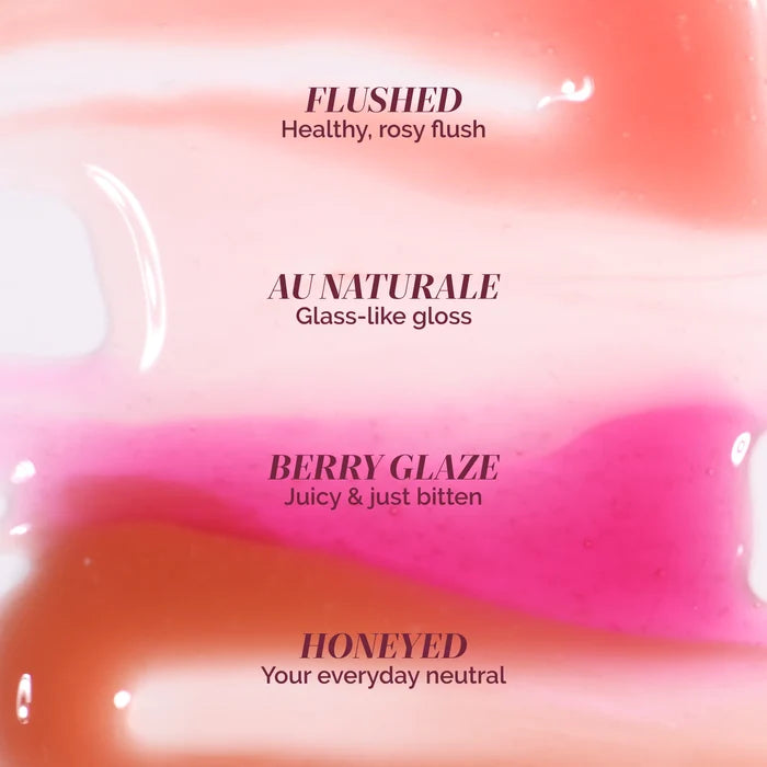 LONDONTOWN’s Quench Glow Buttery Lip Oil in Berry Glaze is shown as a glossy swatch—a juicy pink lip oil that delivers plush shine and a sheer wash of color.