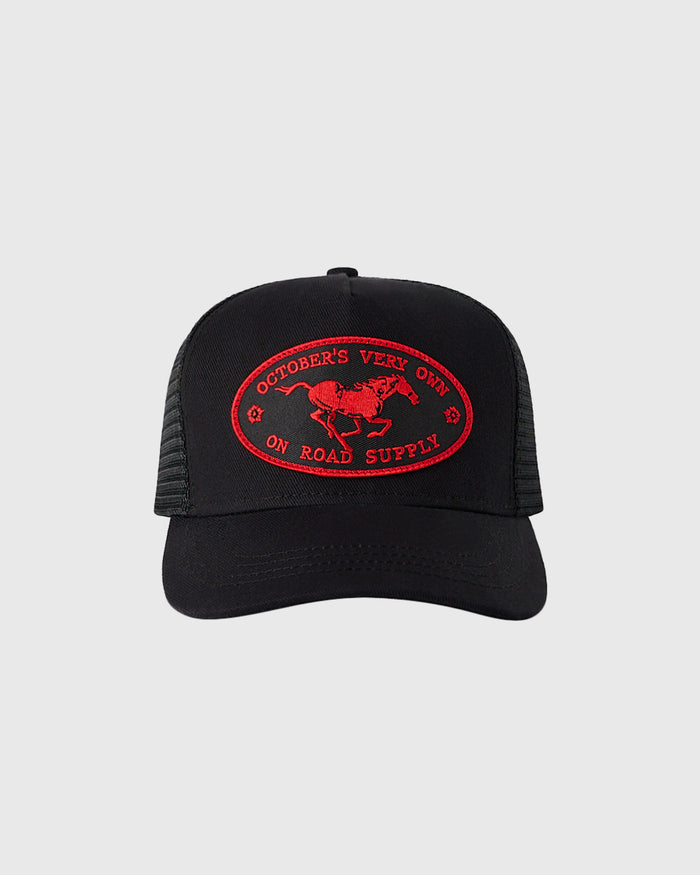 Black trucker hat with red embroidered oval patch featuring horse and "October's Vert On Road Supply" text.