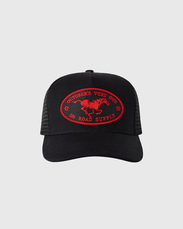 Black trucker hat with mesh back panels and red embroidered oval logo featuring horse and text.
