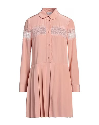 Red Valentino blush shirt dress hanging on a wooden hanger, showcasing its soft fabric and stylish collar details.