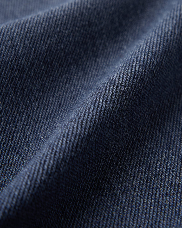 Royal navy textured terry fabric with ribbed weave pattern and soft folds.