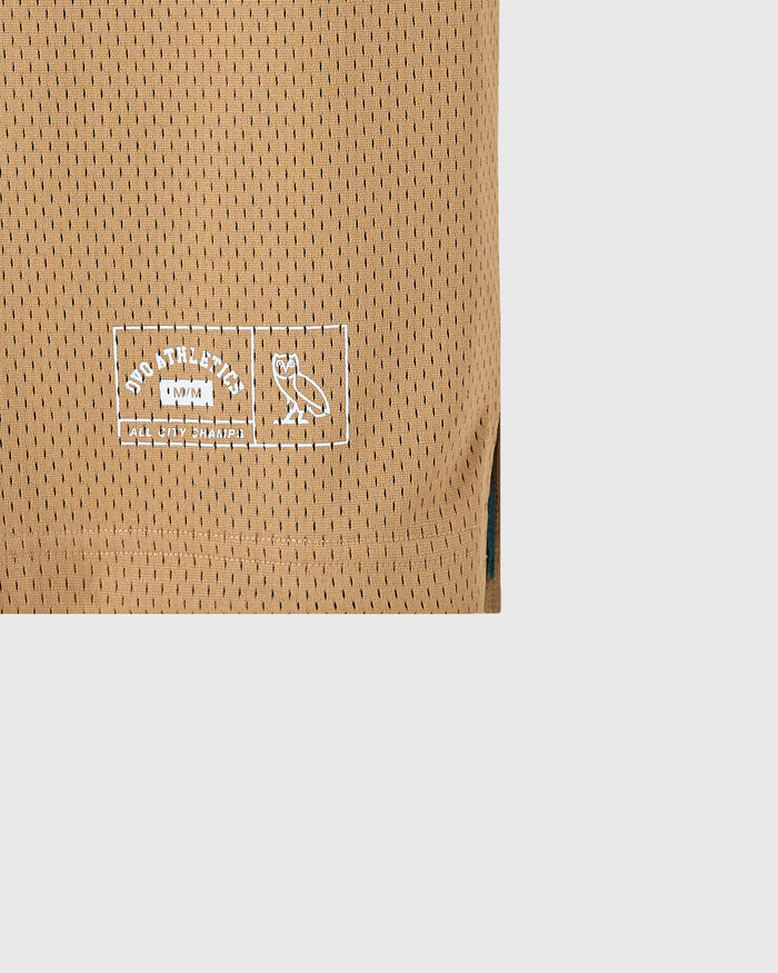 Camel mesh basketball jersey with white embroidered logo on chest and dark side panel detail.
