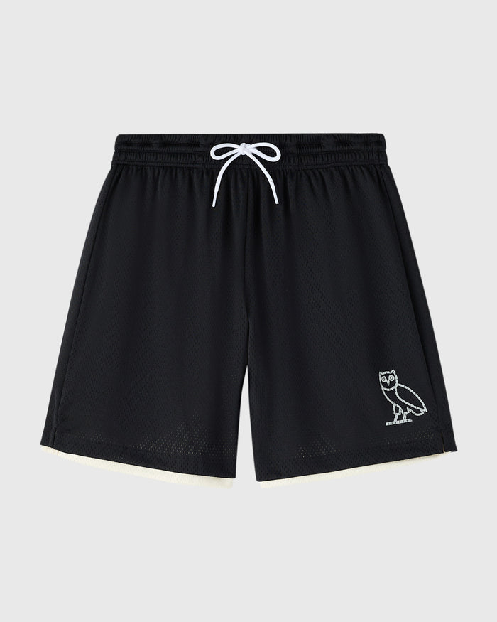 Black mesh shorts with cream reverse side, white drawstring, and owl graphic on right leg.