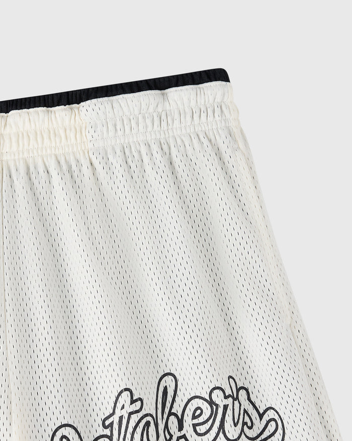 Cream mesh short with black waistband and graphic text at hem, showing perforated fabric texture.