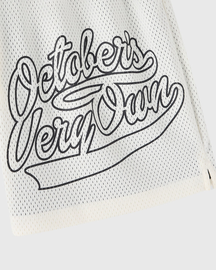 Cream mesh short with black outlined script graphic reading "Pelicans New Orleans" on front.