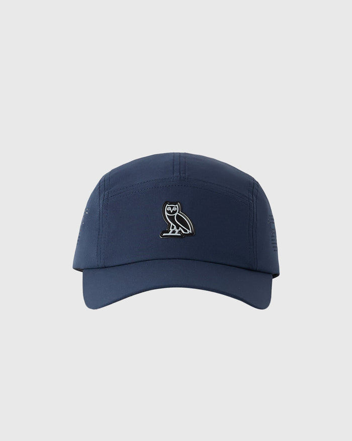 Midnight blue five-panel cap with small owl emblem on front panel.