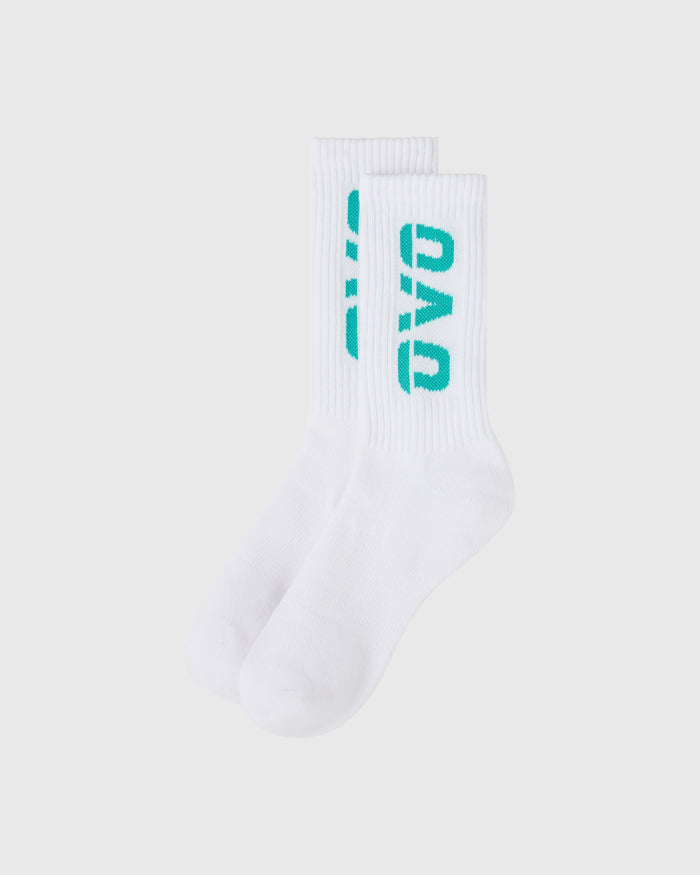 White crew socks with teal branding and vertical ribbed texture throughout.