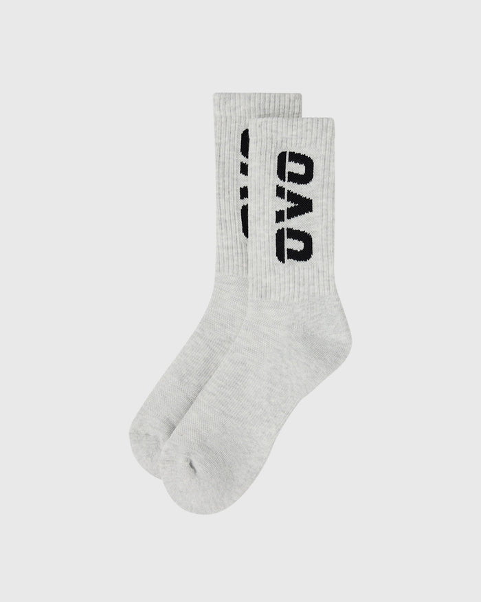 Pair of light grey crew socks with black text branding on the cuff.