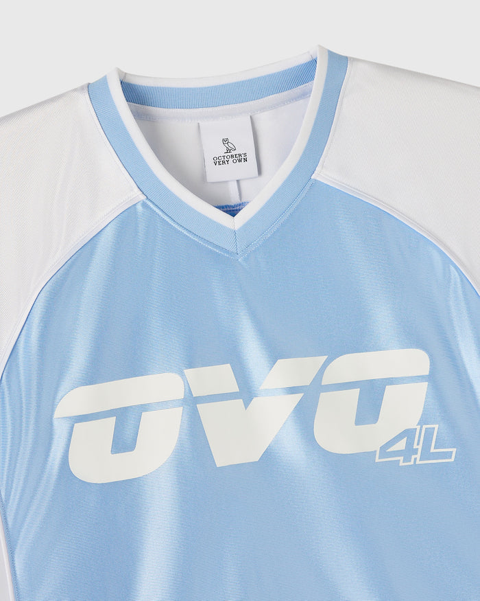 Light blue and white colorblock tee with "OVO 4L" graphic and v-neckline with ribbed trim.