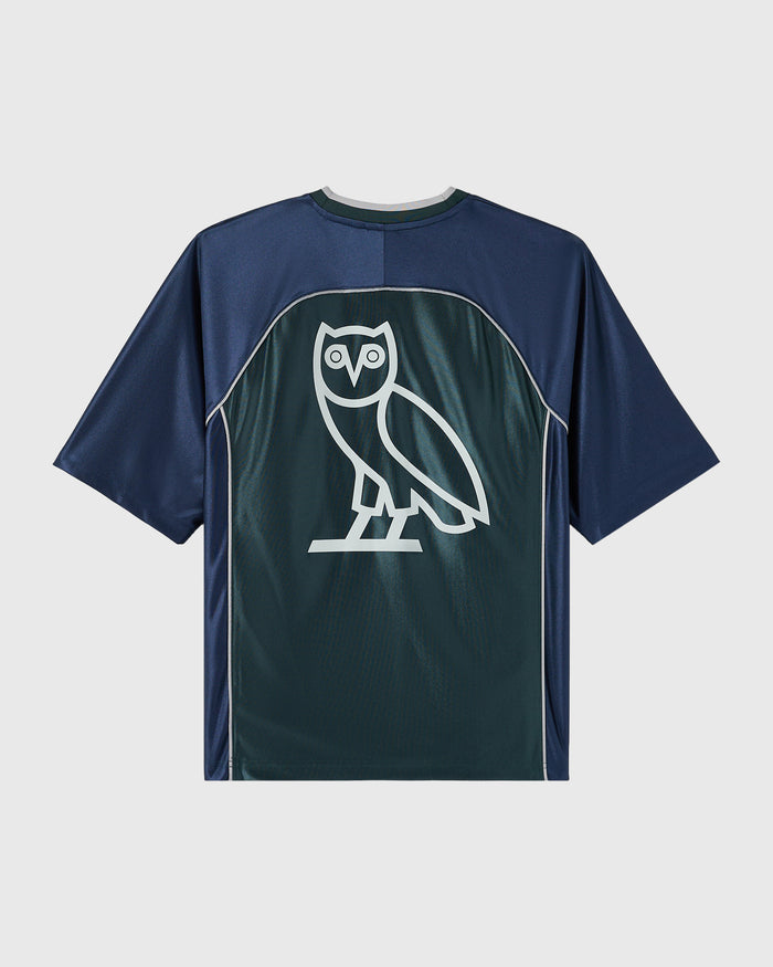 Midnight green and navy colorblock tee with white owl graphic on back panel.