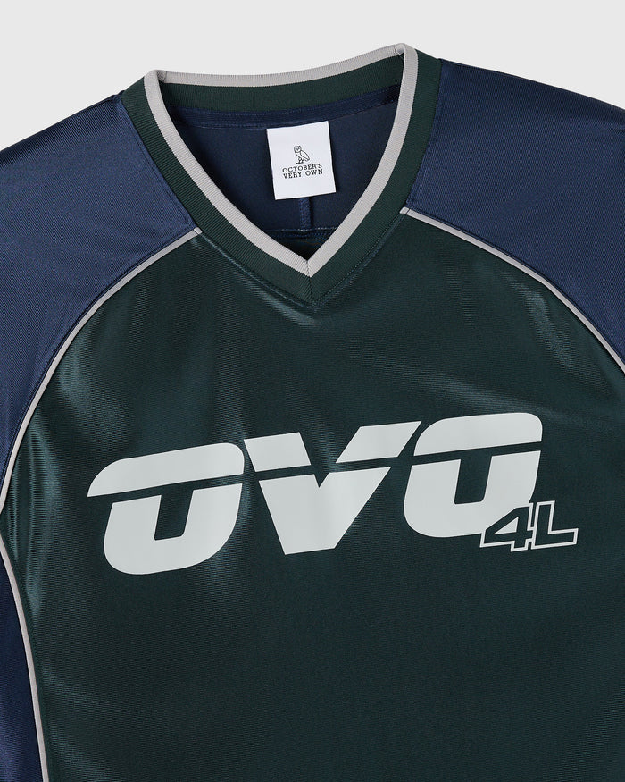Midnight green and navy colorblock tee with white "OVG 4L" graphic and gray trim on v-neckline and sleeves.