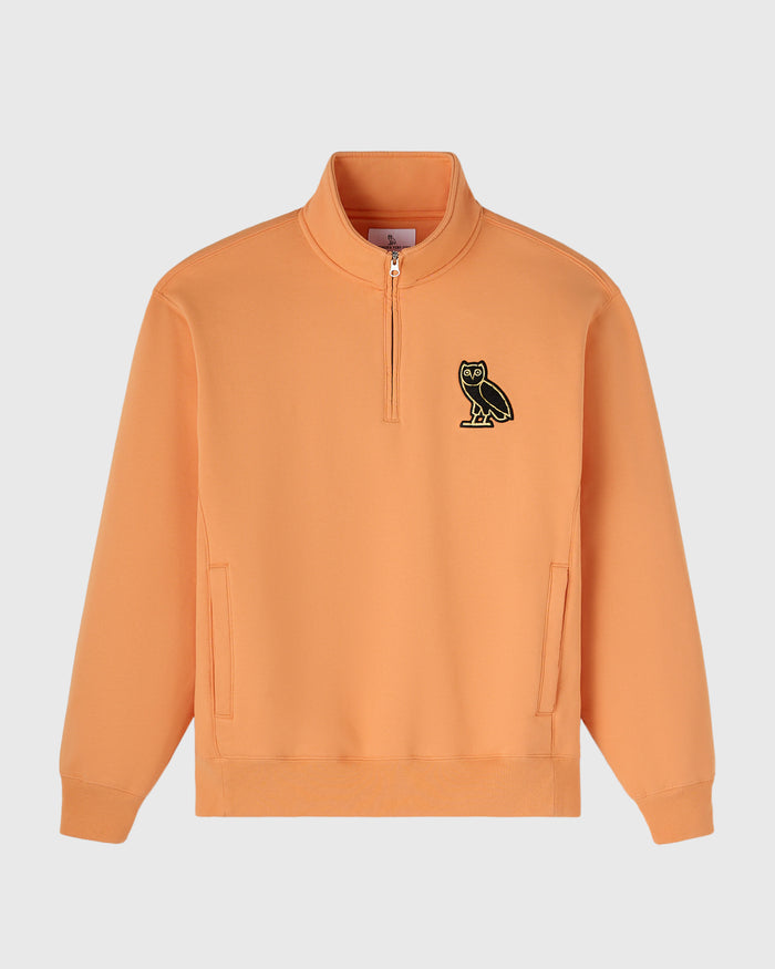 Peach quarter-zip mockneck sweatshirt with small owl embroidered on chest and kangaroo pockets.