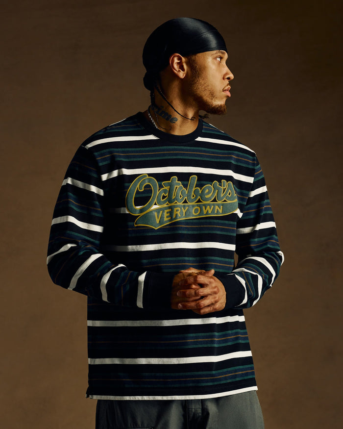 Black long-sleeve tee with horizontal stripes in white and teal, featuring "October's Very Own" script logo in gold.