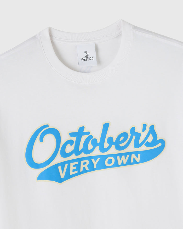 White t-shirt with blue "October's Very Own" sports script graphic on chest.