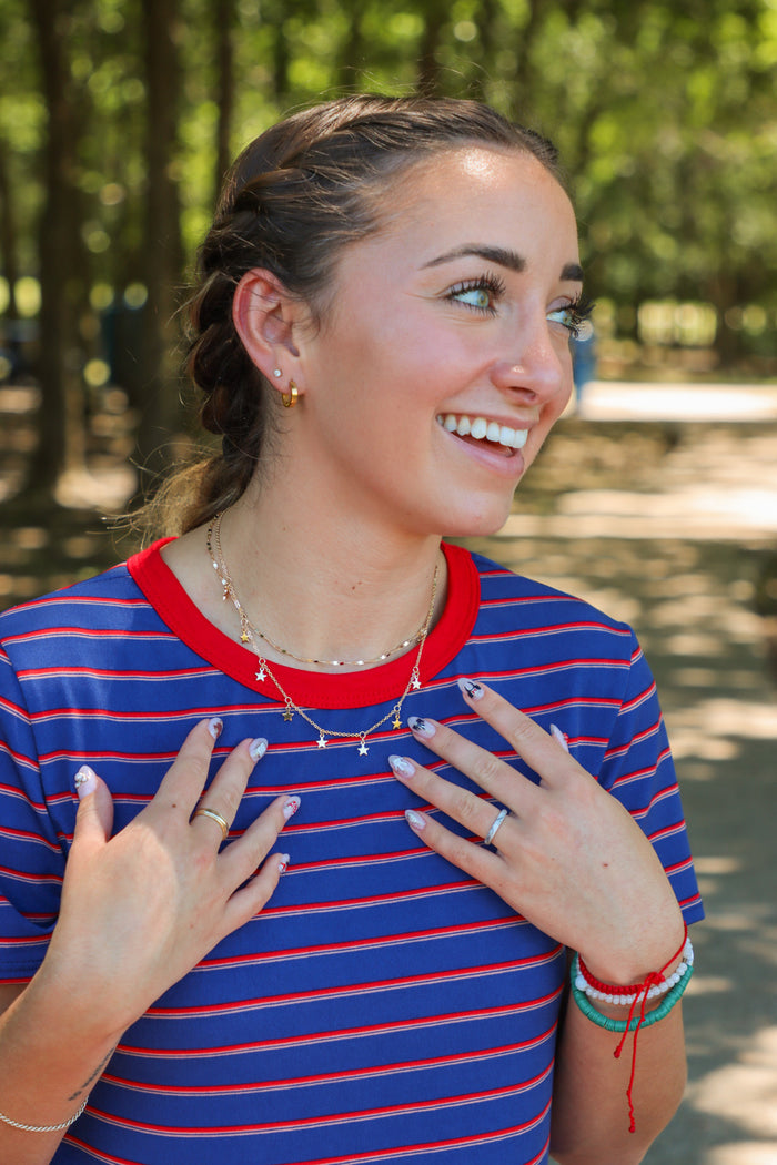 girl wearing gold star necklace