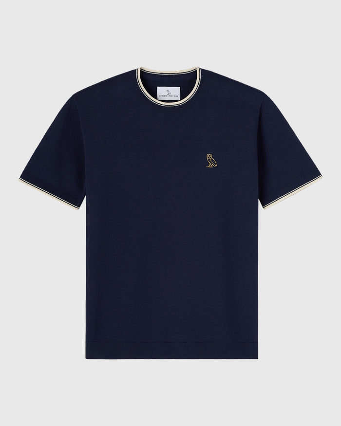 Navy short-sleeve sweater t-shirt with cream tipping on neckline and sleeves, small owl embroidery on chest.
