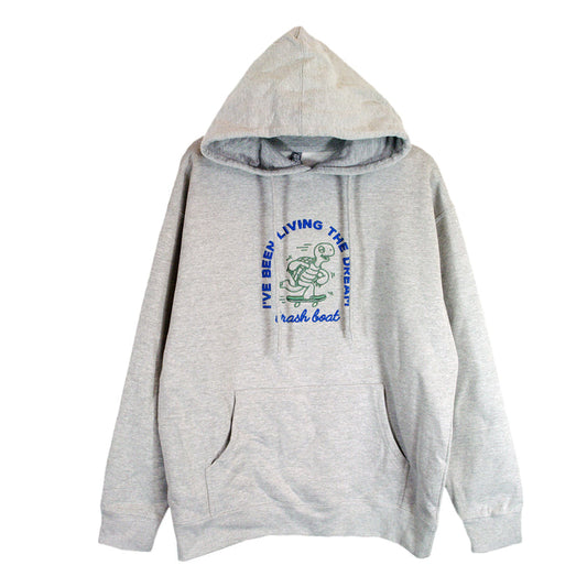 A light gray Trash Boat hoodie with a front pocket, featuring a cartoon frog rowing a boat. “I’VE BEEN LIVING THE BREAK” appears above the image and “break boat” is written below in blue and green letters.