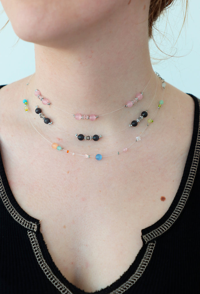 girl poses with three chokers on