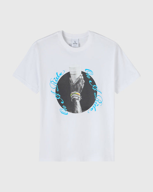 White t-shirt with black and white circular photograph of a hand wearing bracelets, surrounded by blue curved text.