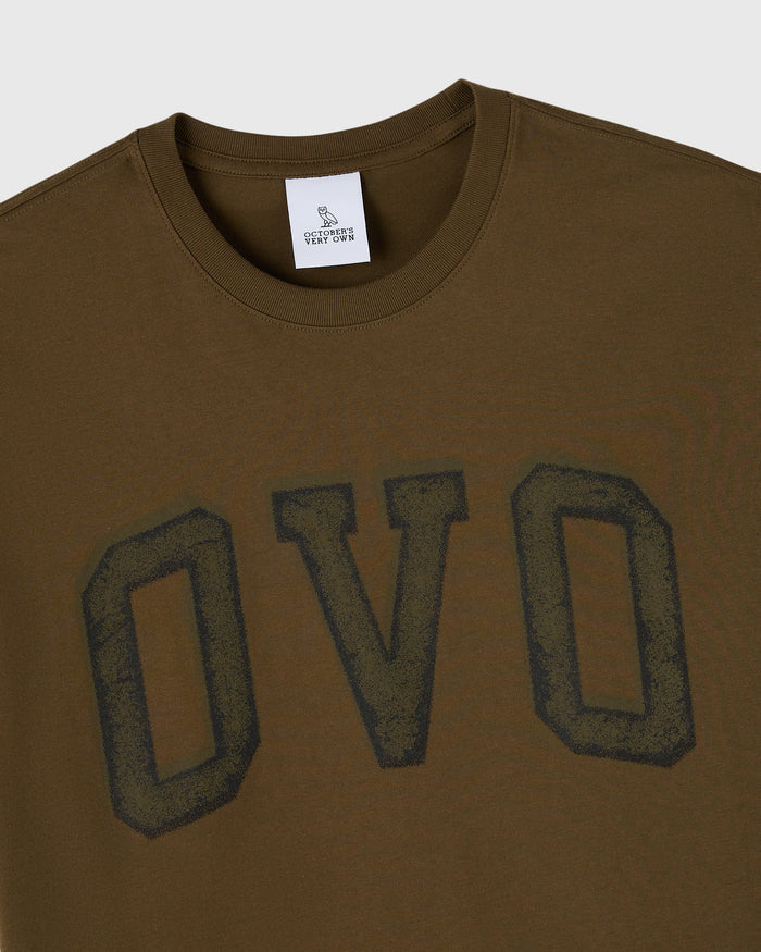 Moss-colored crewneck tee with large distressed arch graphic on chest.
